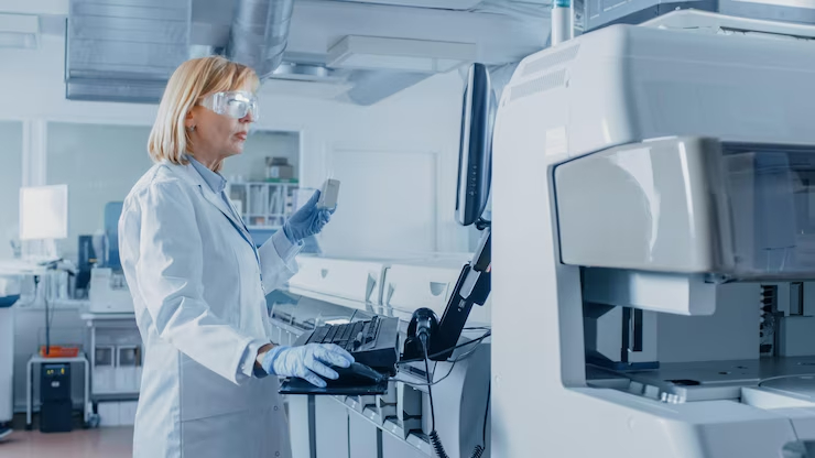 1.woman-lab-wearing-white-coat-goggles-stands-front-large-computer-monitor_861143-1649