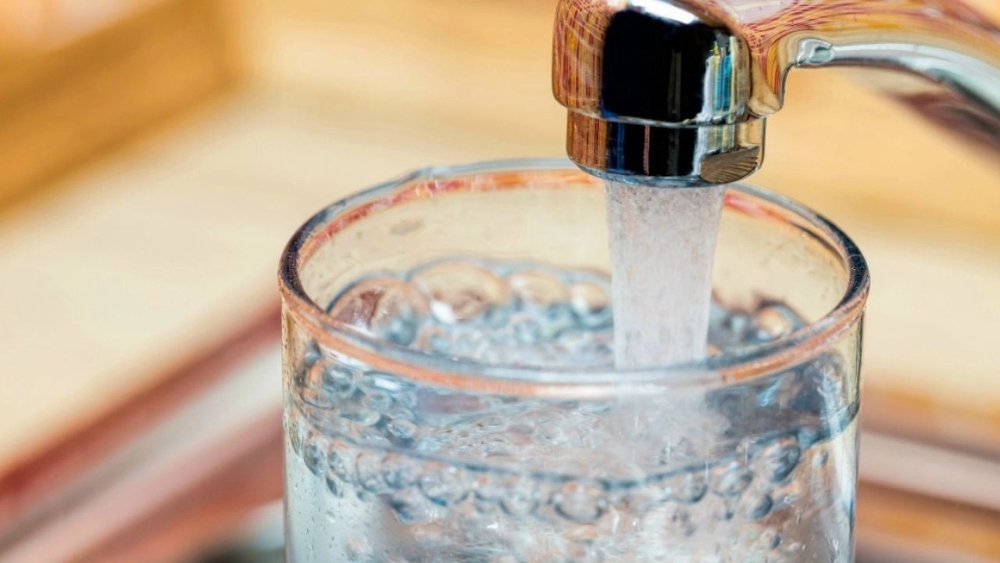 filling a glass of water from the tap